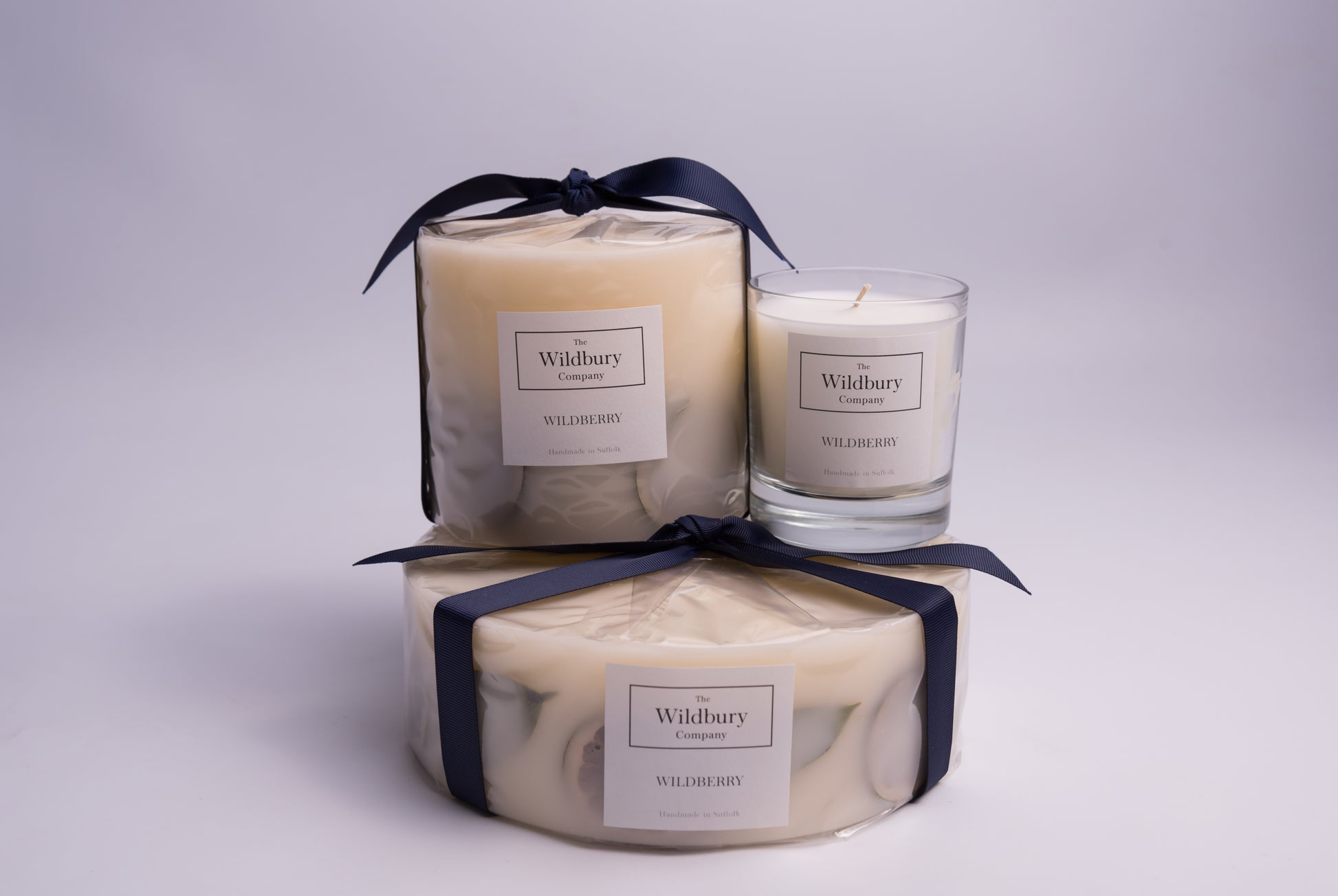 Group of three Wildberry Fragranced Candles displaying Signature, Large and Extra Large sizes